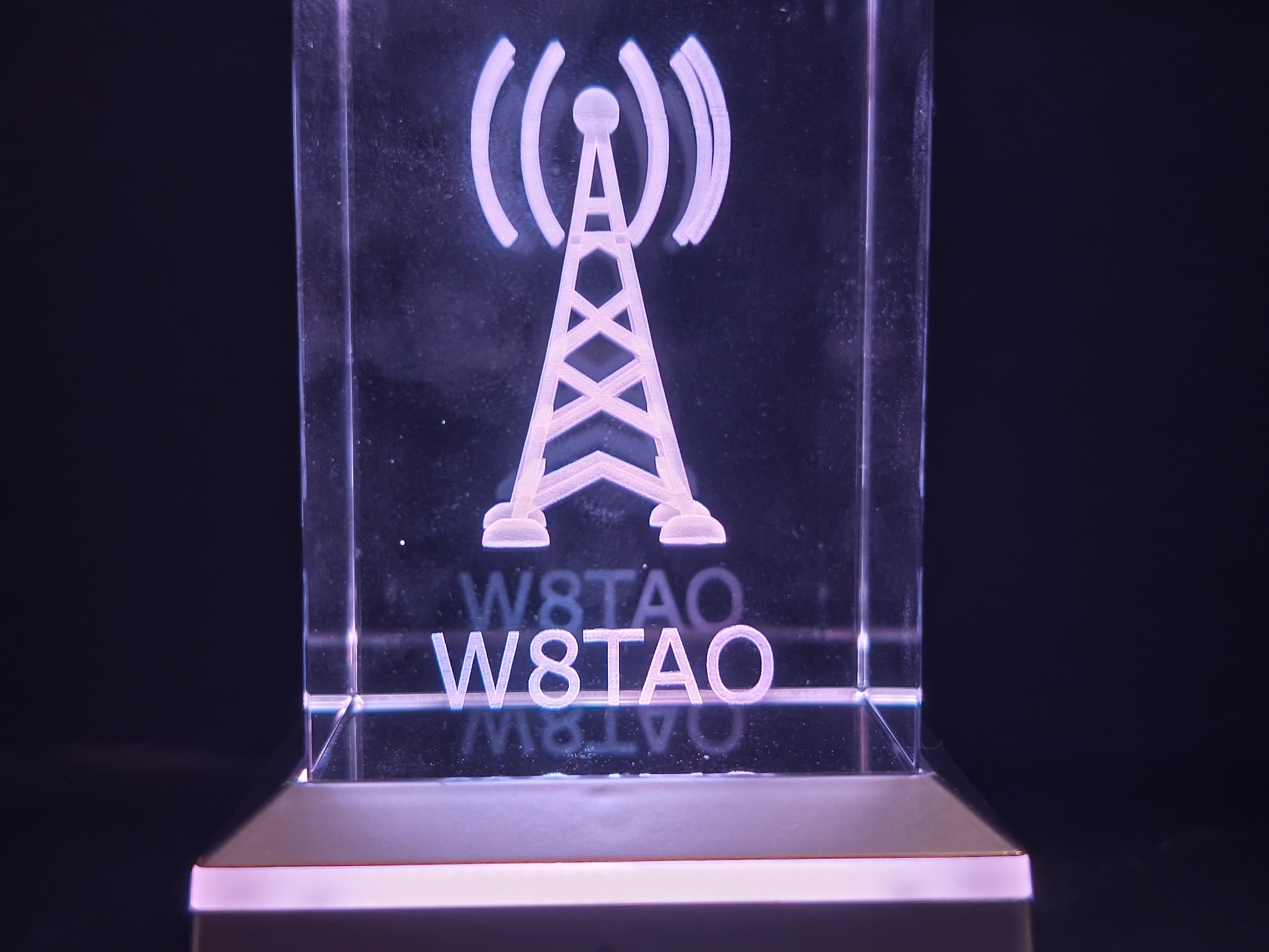 Radio tower and W8TAO call sign engraved in a rectangular crystal with purple lighting
